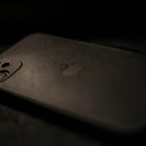 Home Detailed view highlighting a smartphone with a sleek black case, emphasizing elegance and modern design.
